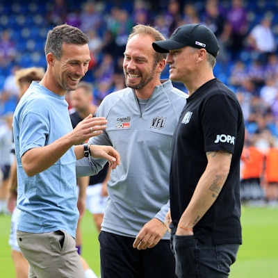 Der Kölner Martin Heck (M.), Co-Trainer beim VfL Osnabrück, und VfL-Chefcoach Tobias Schweinsteiger (r.) tauschen sich mit Karlsruhes Trainer Christian Eichner aus.