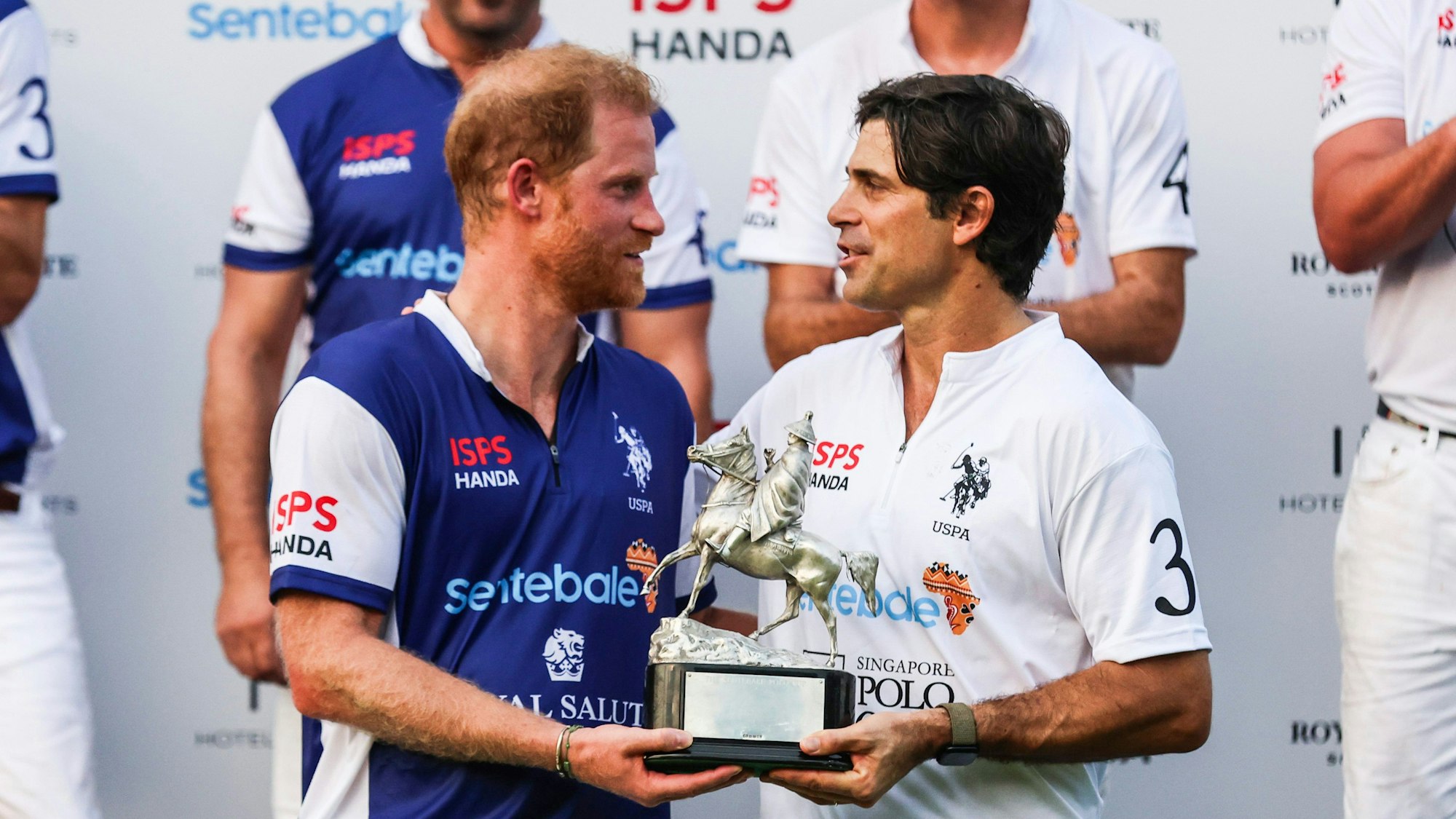 Der britische Prinz Harry und der argentinische Polospieler Nacho Figueras reagieren mit der Trophäe nach dem Spiel, das mit einem 7:7-Unentschieden im Sentebale ISPS Handa Polo Cup in Singapur endete.