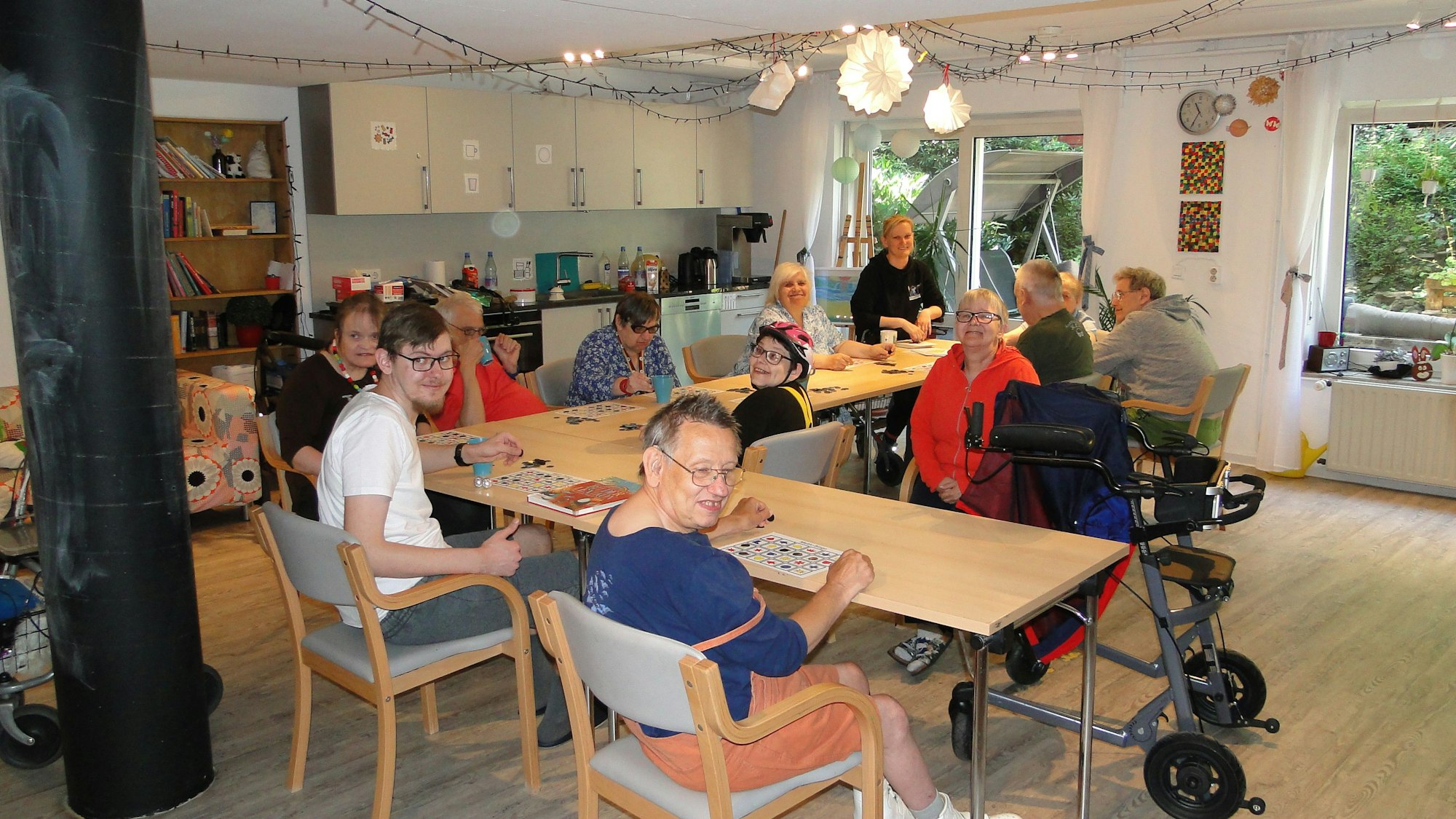 Die Bewohner sitzen an einem Tisch und spielen Spiele.