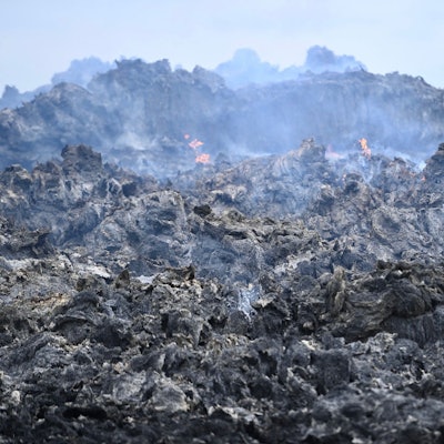 Das Bild zeigt einen Blick auf die Strohmiete. Einzelne Flammen züngeln noch heraus.