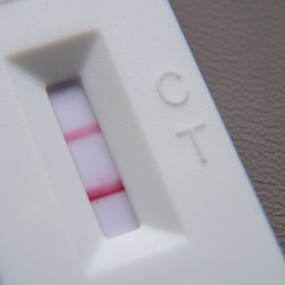 Ein positiver Corona-Schnelltest liegt auf einem Tisch.