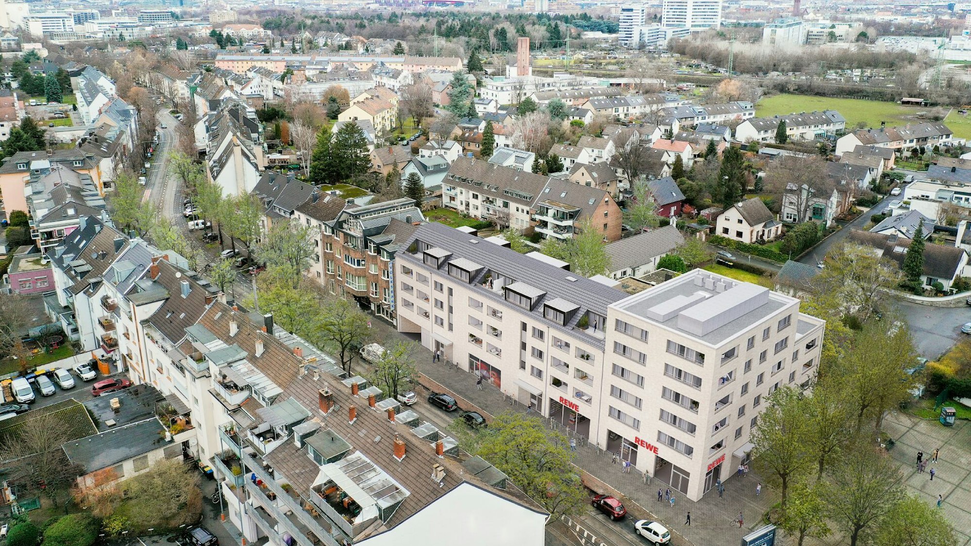 Der Stadtteil Poll ist von oben zu sehen, im Vordergrund steht ein mehrstöckiges großes Gebäude.