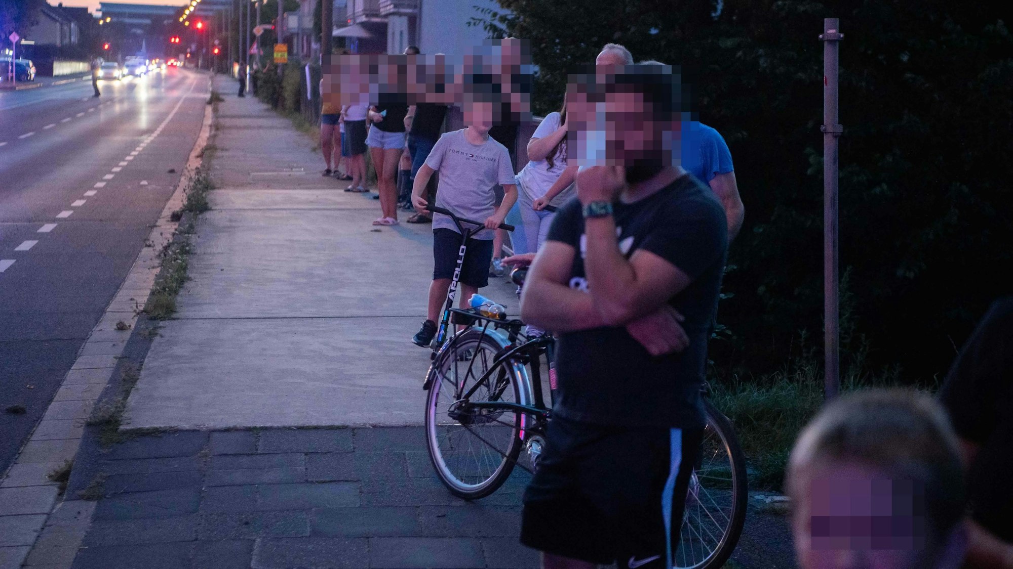 Das Bild zeigt zahlreiche Menschen, die in Richtung des Hubschraubers blicken. Einige filmen die Szenerie auch.