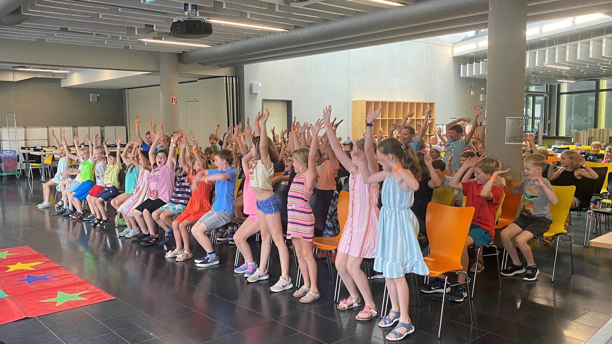 Kinder reißen die Hände hoch.