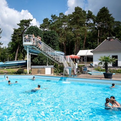 Außenbereich eines Freibads mit Rutsche.