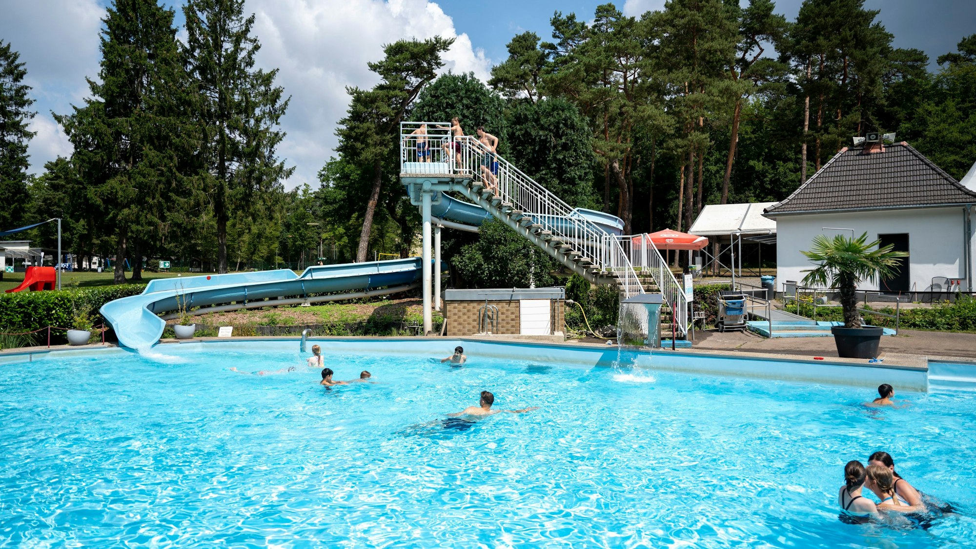 Außenbereich eines Freibads mit Rutsche.