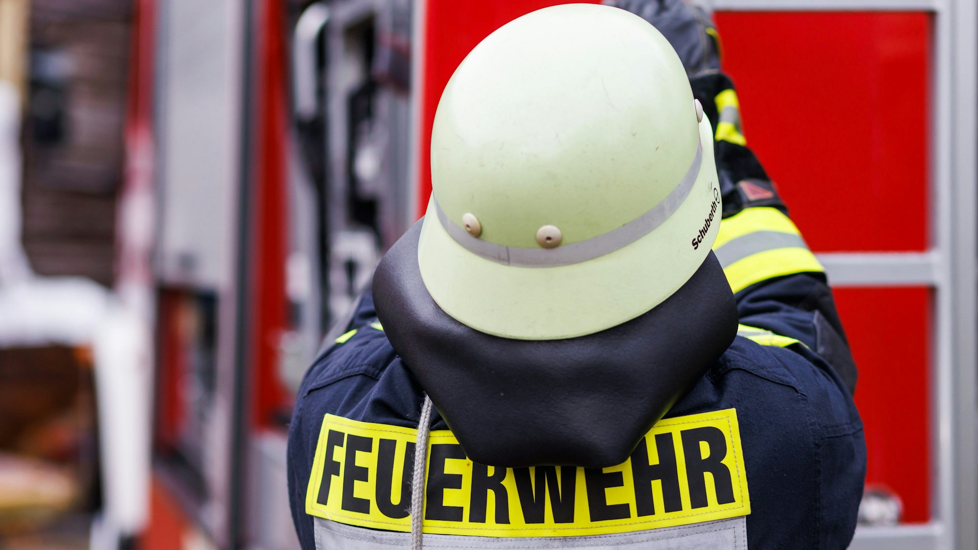 Ein Feuerwehrmann holt während einer Einsatzübung einer Freiwilligen Feuerwehr eine Leiter vom Dach eines Einsatzfahrzeugs. (Symbolbild)