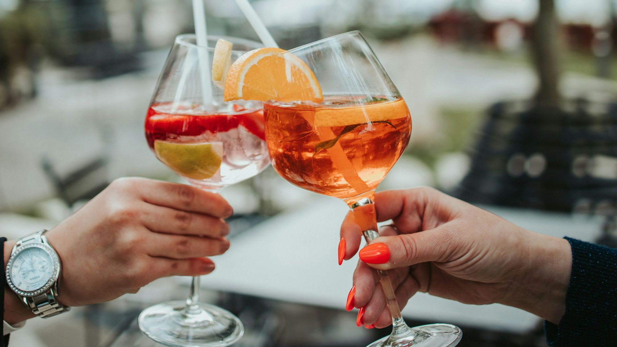 Mit Cocktailgläsern wird angestoßen.