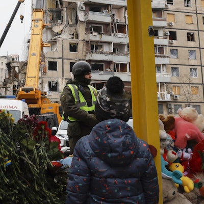 Scene in Ukraine Children look at an apartment building struck by a missile in Dnipro on Jan. 17, 2023, amid Russia's war on Ukraine.
