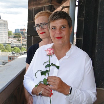 Sabine und Renate stehen hintereinander auf dem Kirchturm. Im Hintergrund sind noch die Domspitzen zu erahnen.