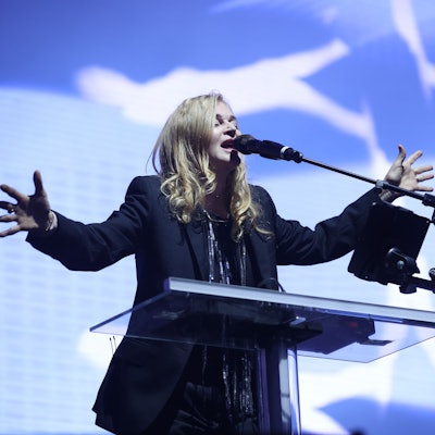 Sängerin Inga Humpe steht auf der Bühne des Gamescom City Festivals. Sie trägt einen dunklen Blazer und hat die Hände weit ausgebreitet.