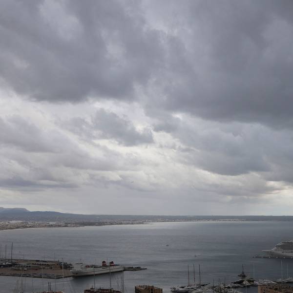 Dunkle Regenwolken hängen über der Bucht und einem Hafen auf Mallorca (Symbolbild).