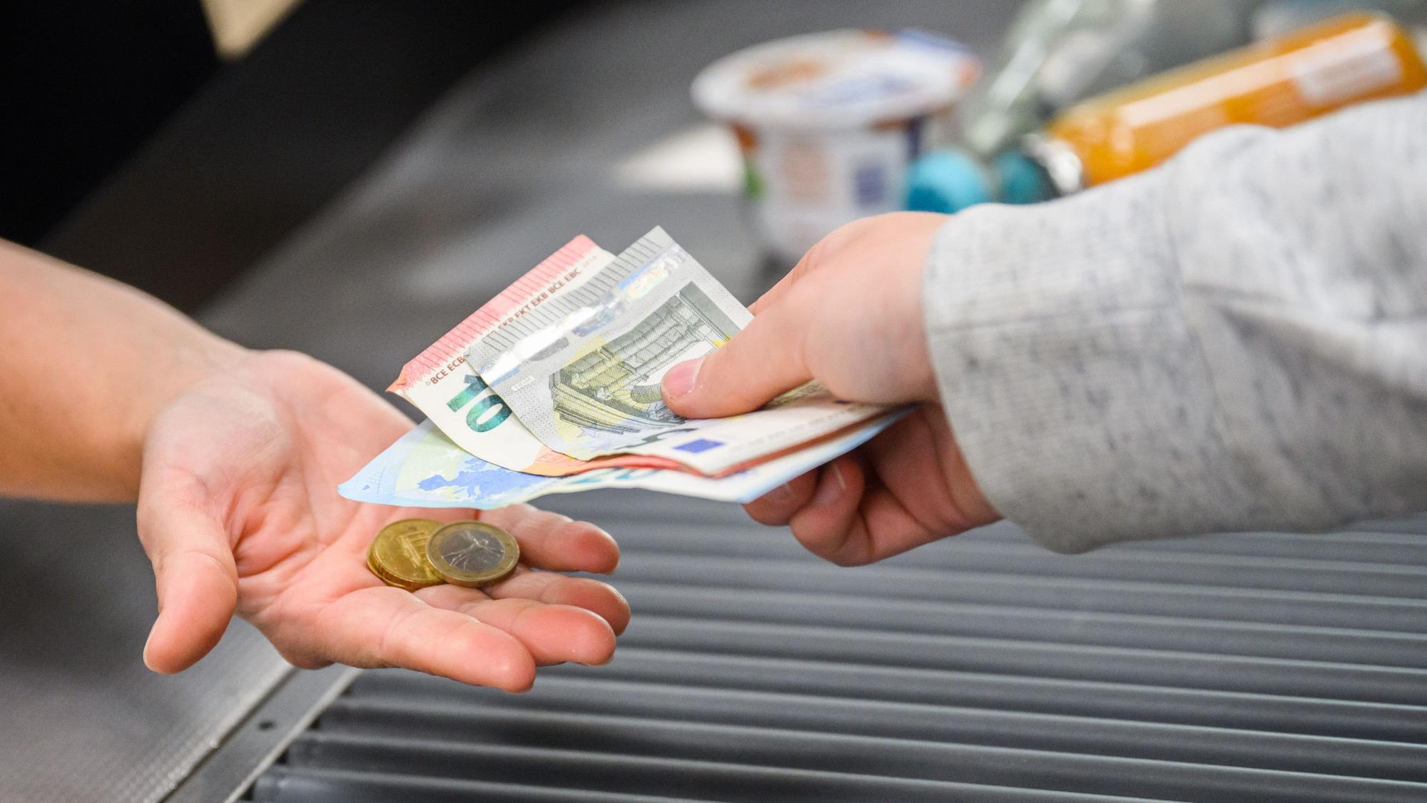 30.08.2023, Niedersachsen, Hannover: Eine Kassiererin gibt einer Kundin Wechselgeld an der Kasse eines Supermarktes. Das Statistische Bundesamt gibt am 30. August die Inflationsrate für August 2023 bekannt. Foto: Julian Stratenschulte/dpa +++ dpa-Bildfunk +++