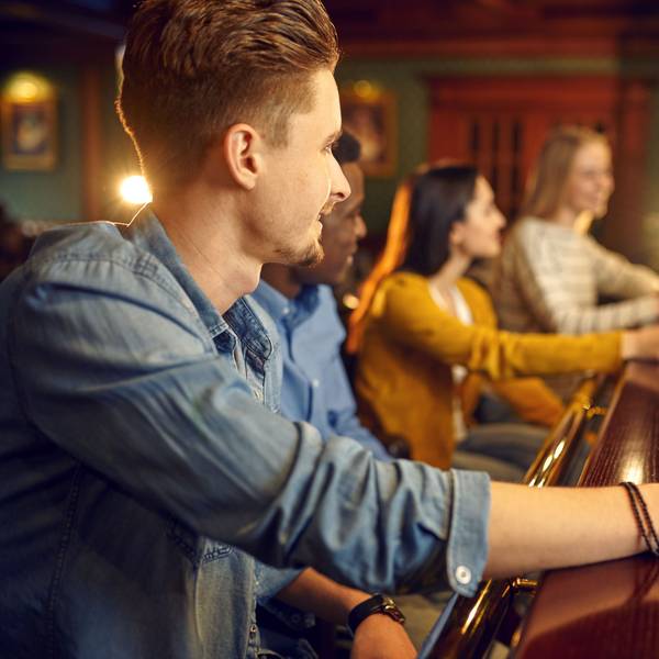 Junge Menschen sitzen in einer Bar und trinken Bier. (Symbolbild)