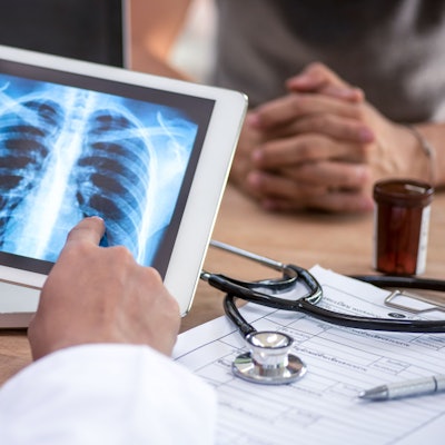 Ein Arzt liest den Lungen-Scan auf einem digitalen Tablet-Bildschirm.