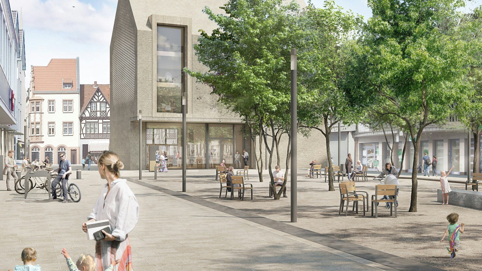Das Bild zeigt den Janshof mit vielen Sitzmöbeln und Bäumen. Im Hintergrund ist der neue Rathausanbau mit seiner beigen Fassade zu sehen.