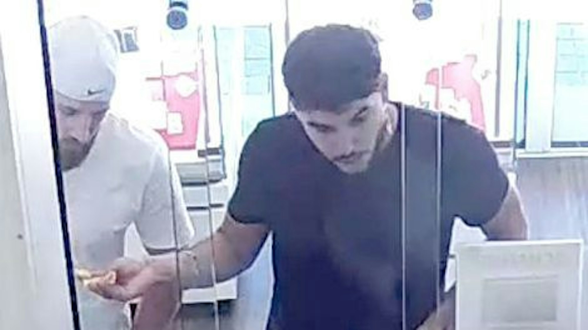 Zwei Männer auf den Bildern einer Überwachungskamera.