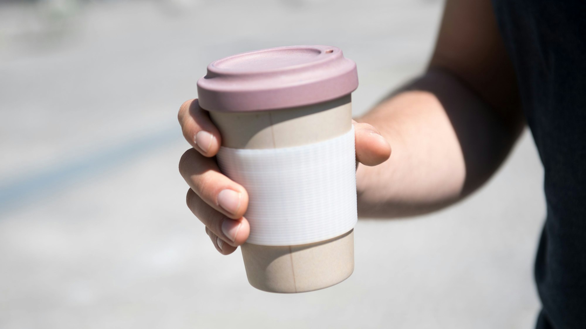 Eine Person hält einen Kaffeebecher. Mit einem Kaffee hat in Espelkamp bei Bielefeld einen Räuber in die Flucht geschlagen. (Symbolbild)