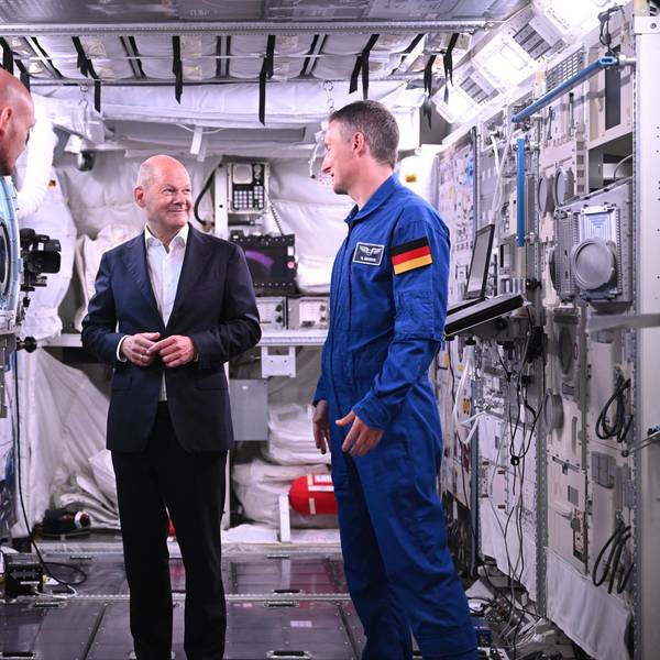 Bundeskanzler Olaf Scholz (SPD, M) steht mit den deutschen ESA-Astronauten Matthias Maurer (r) und Alexander Gerst in einem Modell des Columbus-Moduls in der Neutral Bouyancy Facility, während eines Besuchs im Astronautenzentrum der Europäischen Weltraumorganisation ESA.