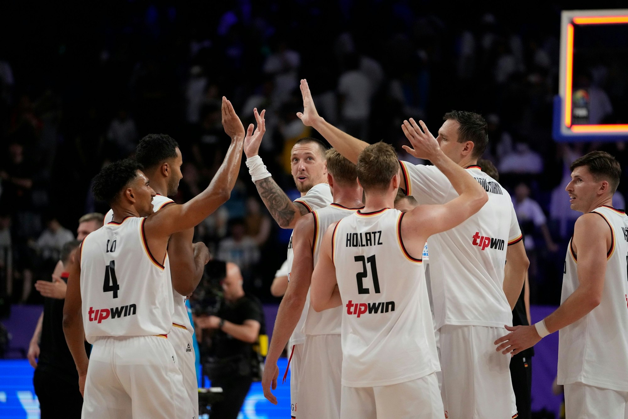 German team members celebrate after defeating Slovenia in their Basketball World Cup group K match in Okinawa, southern Japan, Sunday, Sept. 3, 2023. (AP Photo/Hiro Komae)