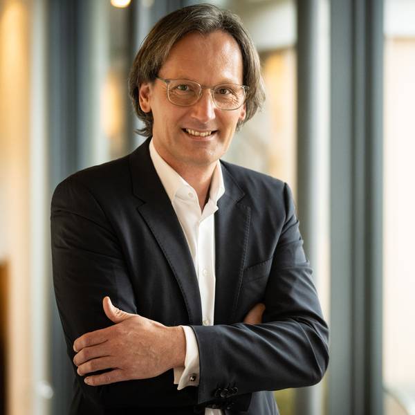 Der neue Generaldirektor des Grandhotel Schloss Bensberg steht mit verschränkten Armen an einem Fenster.