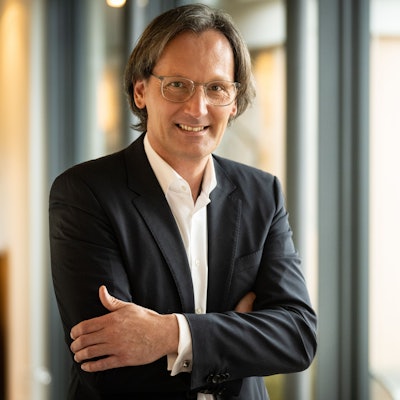 Der neue Generaldirektor des Grandhotel Schloss Bensberg steht mit verschränkten Armen an einem Fenster.