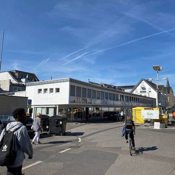 Zu sehen ist der Platz, auf dem Baumaschinen und -material lagert. Im Hintergrund ist der Rathausneubau zu erkennen.