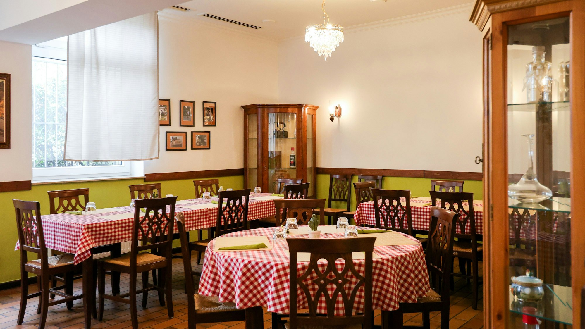 Rot-weiß-karierte Tischdecken auf den eingedeckten Tischen im Innenraum des Flo Salento.