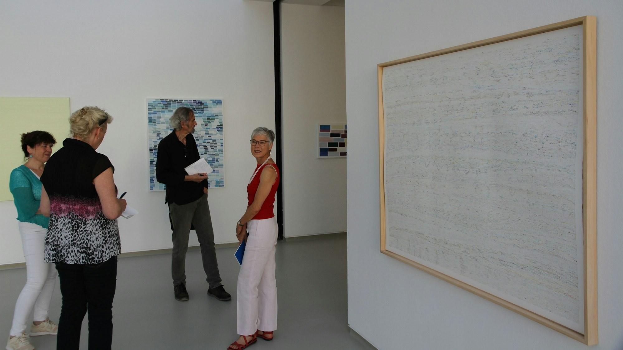 Drei Frauen und ein Mann in einer Ausstellung mit Bildern im Stadtmuseum