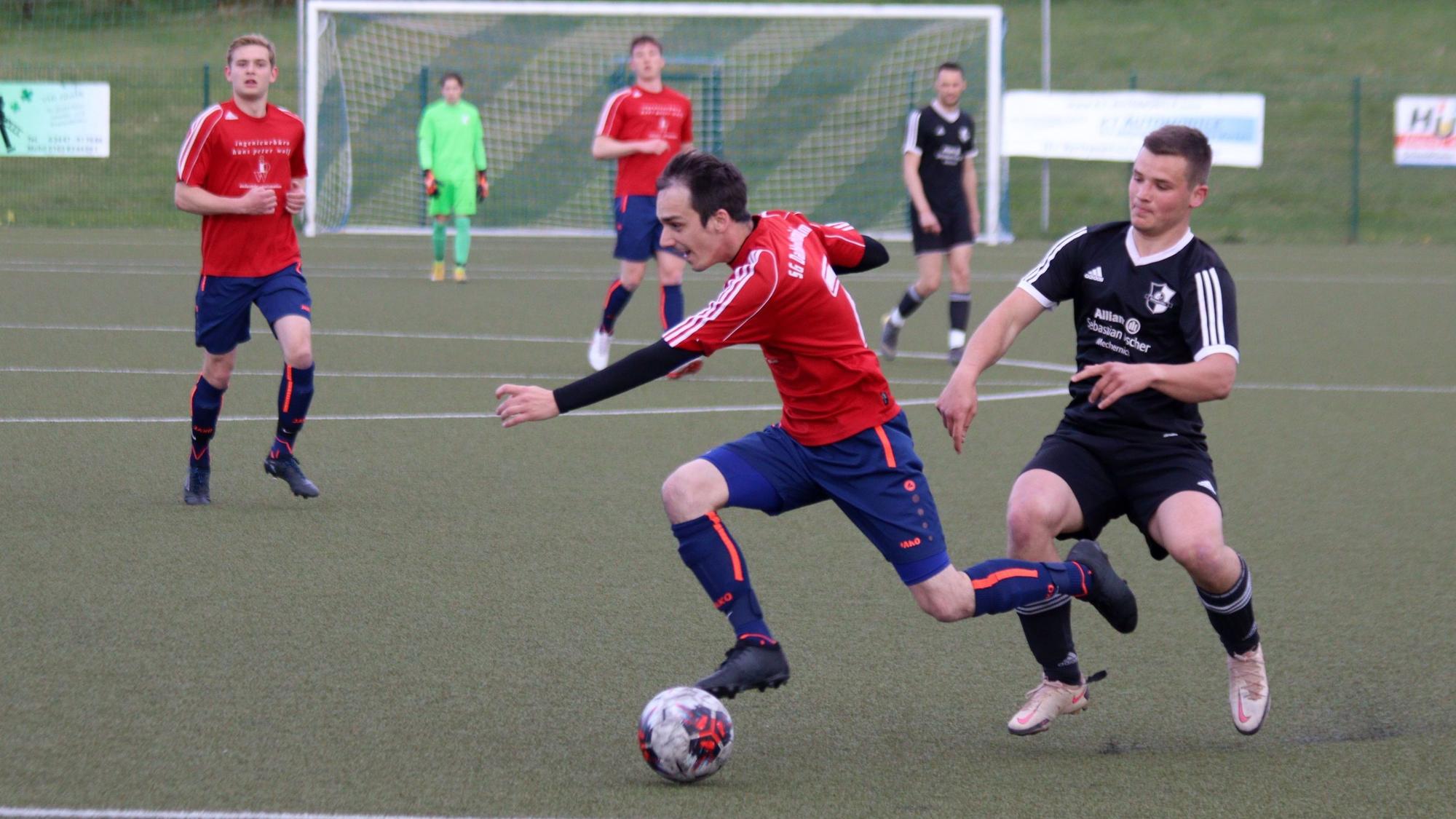 Ein Spieler der SG Dahlem-Schmidtheim wird von einem Kicker der Eintracht Eifel verfolgt.