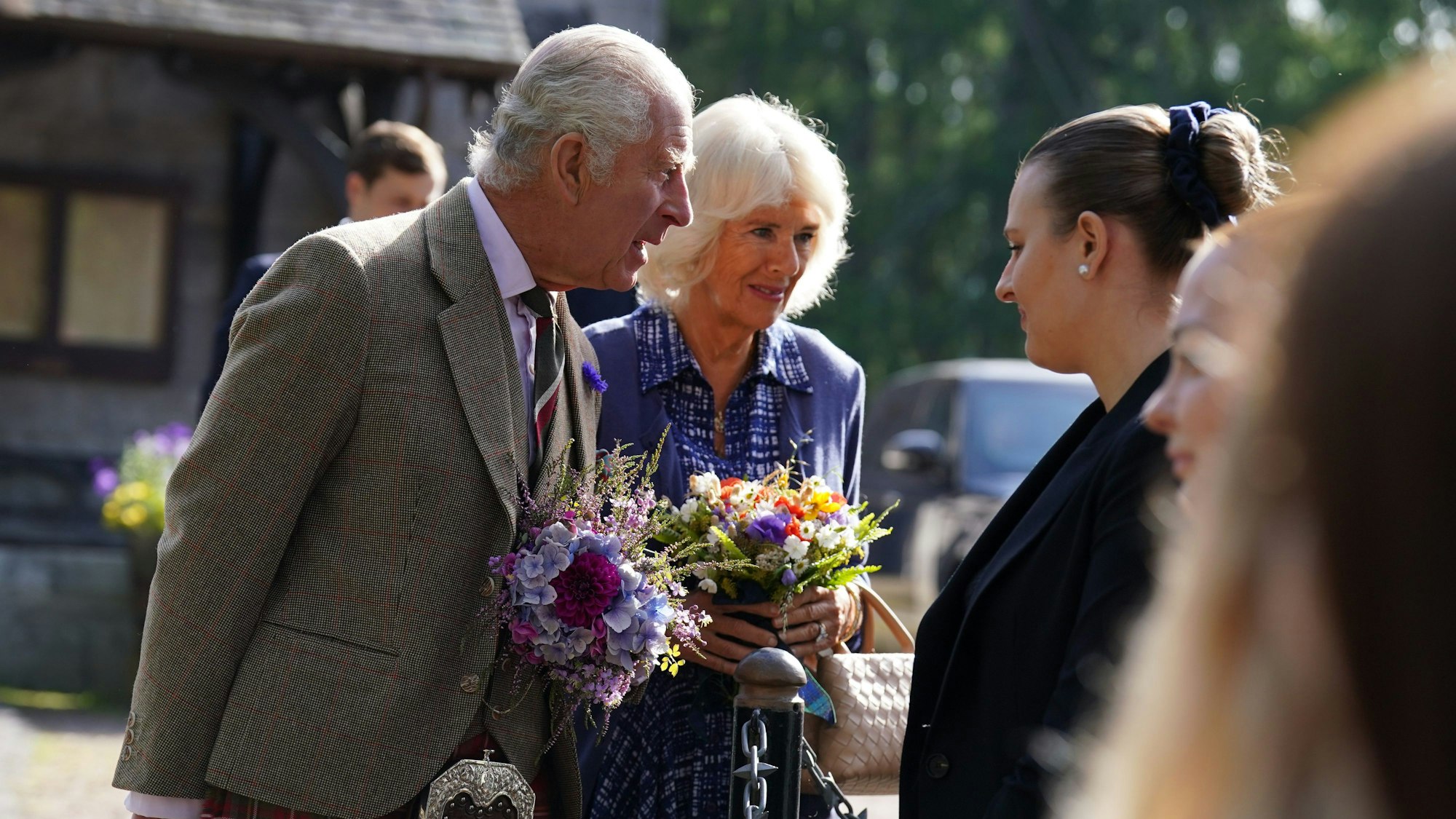 König Charles III. (l-r) und Königin Camilla treffen nach einem Gottesdienst anlässlich des ersten Todestages von Königin Elisabeth II. mit Mitarbeitern des Anwesens und der Öffentlichkeit zusammen, als sie die Pfarrkirche von Crathie in der Nähe von Balmoral verlassen.
