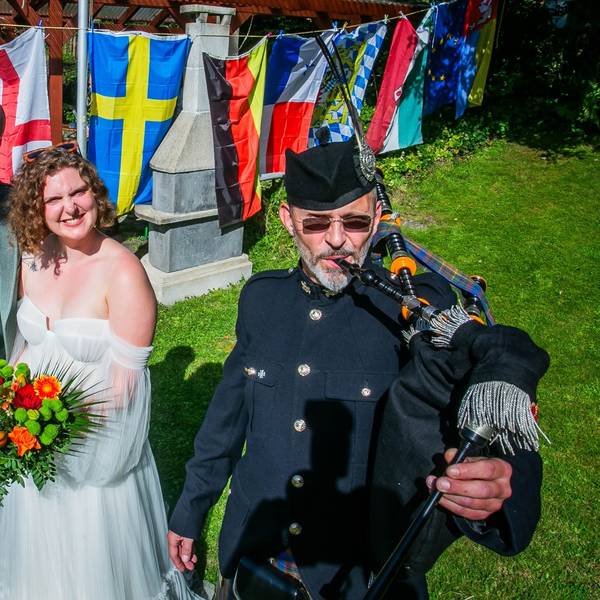 Mit Musik von Dudelsackspieler Michael Hoffmann von der Gruppe „Call of Pipes“ aus Waldbröl feiert das schottische Paar Nils und Anna Fritsch am Samstagnachmittag in Wiehl-Merkausen und im Kreise der weitverzweigten Familie noch einmal Hochzeit. Hier steht das Paar vor den Fahnen der beteiligten Nationen.
