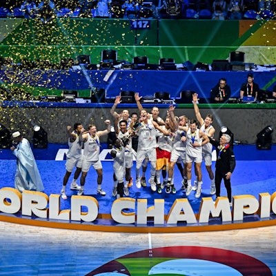 TOPSHOT - Germany's players celebrate with their head coach Gordon Herbert (R) after winning the FIBA Basketball World Cup final game against Serbia in Manila on September 10, 2023. (Photo by SHERWIN VARDELEON / AFP)