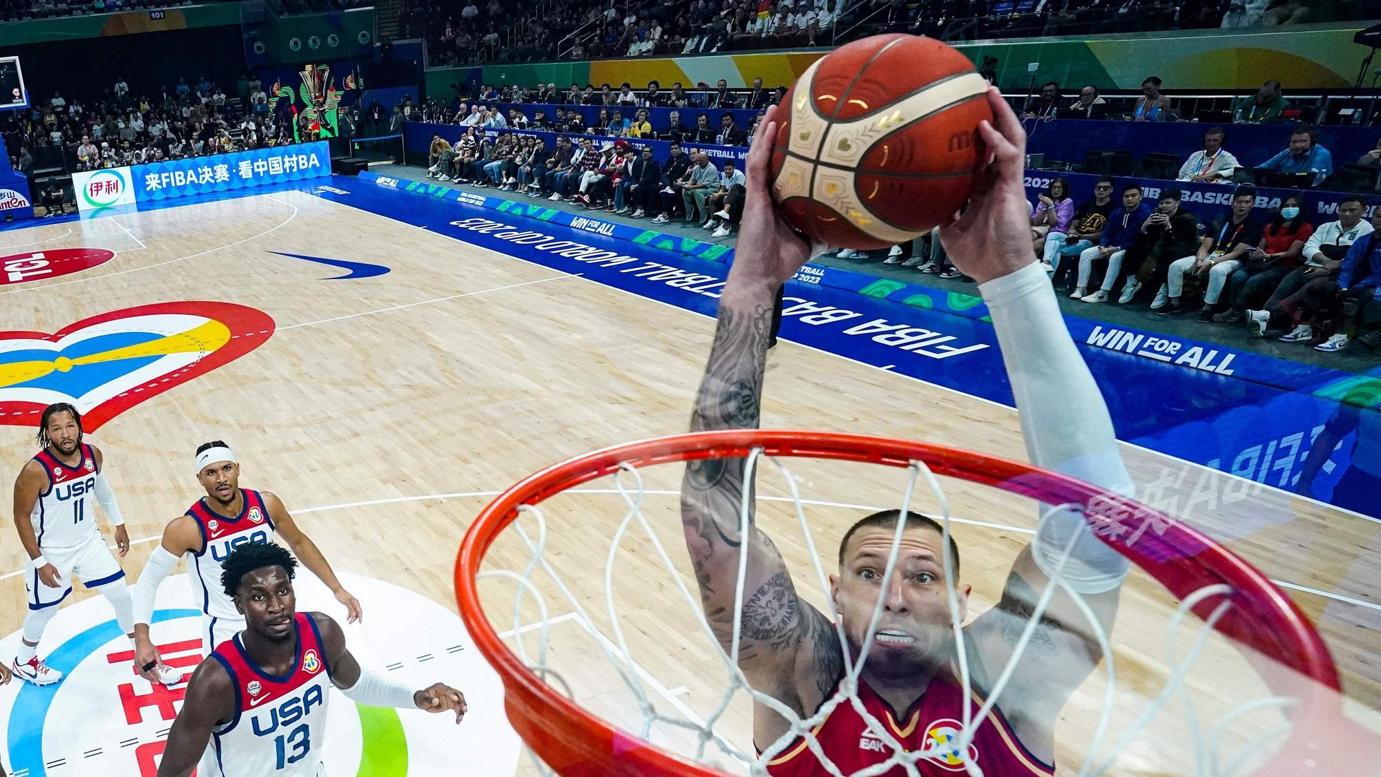 Daniel Theis #10 of Germany dunks the ball past Jaren Jackson Jr. #13 of the United States in the first half during the FIBA Basketball World Cup semifinal game at Mall of Asia Arena in Manila on September 8, 2023. (Photo by POOL / AFP)