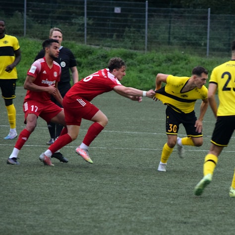 Bergisch Gladbachs Fußballer Nico Kuhbier zieht am Trikot des Hohkeppelers Ansgar Pflüger, um diesen vom Ball fernzuhalten.