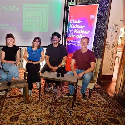 Klubkomm-Mitglieder sitzen an Tischen.