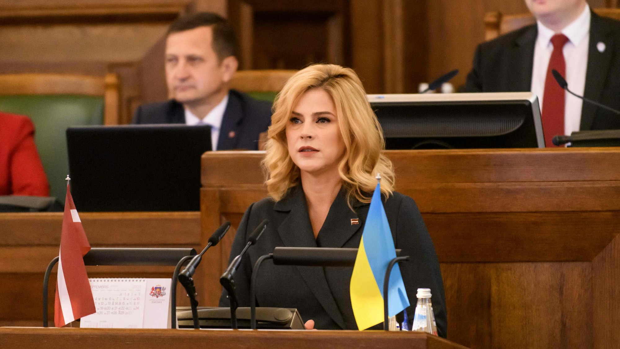 Candidate as new Prime Minister of Latvia Evika Silina of New Unity party (C) speaks at the Parliament of Latvia on September 15, 2023 in Riga, Latvia, prior to the debate and Parliament voting for confirmation of the new Cabinet of Ministers. (Photo by Gints Ivuskans / AFP)