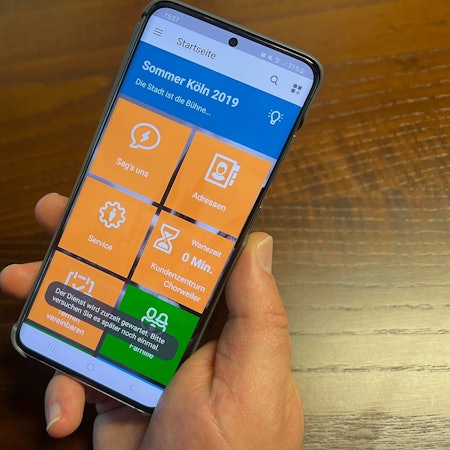 Ein Smartphone mit der Service-App der Stadt Köln