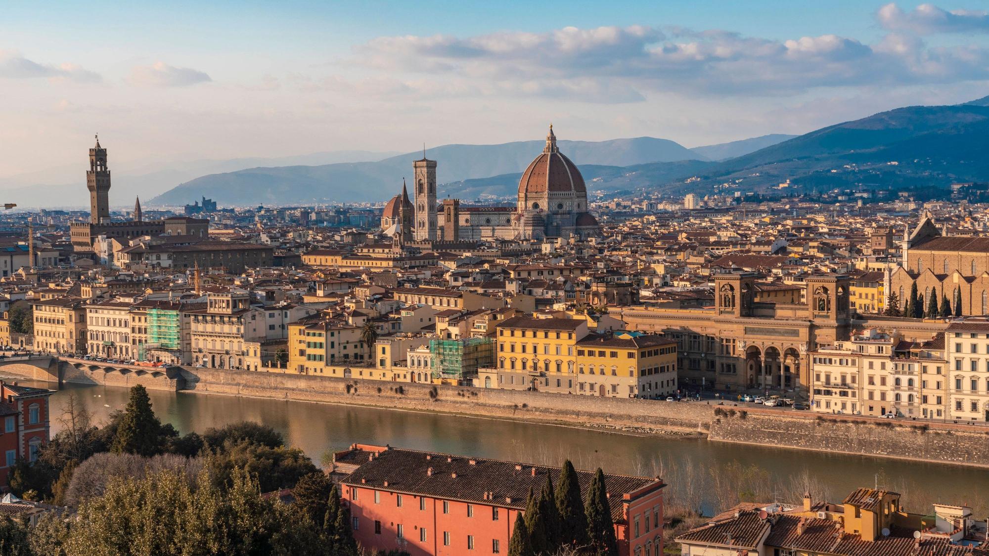 Italy, Tuscany, Florence, Arno River with Florence Cathedral and surrounding buildings in background, Florence Toscana Italy TAMF03475
