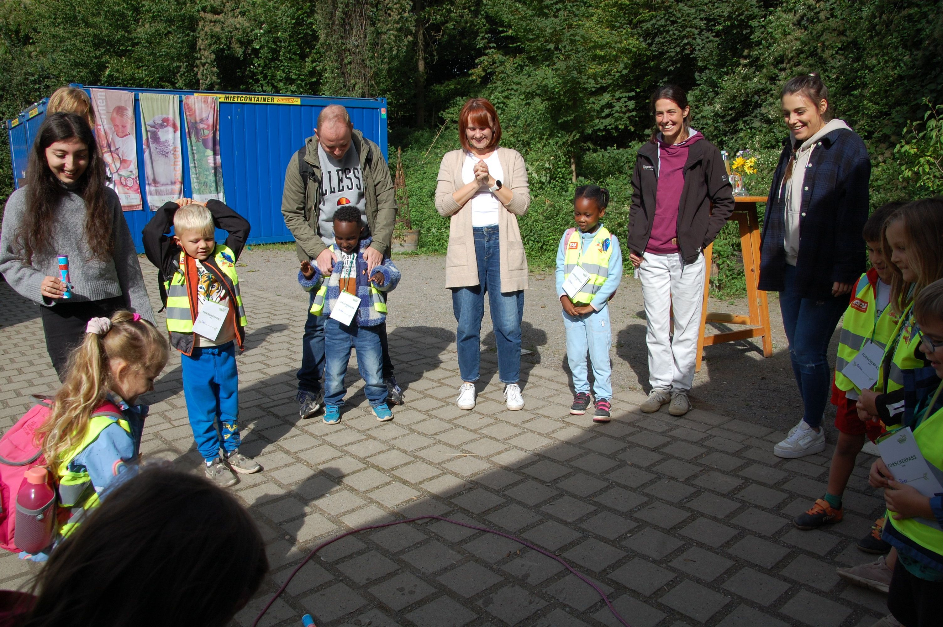 Kindergartenkinder und Erzieher bestaunen den Start der selbstgebastelten Brausetabletten-Rakete.