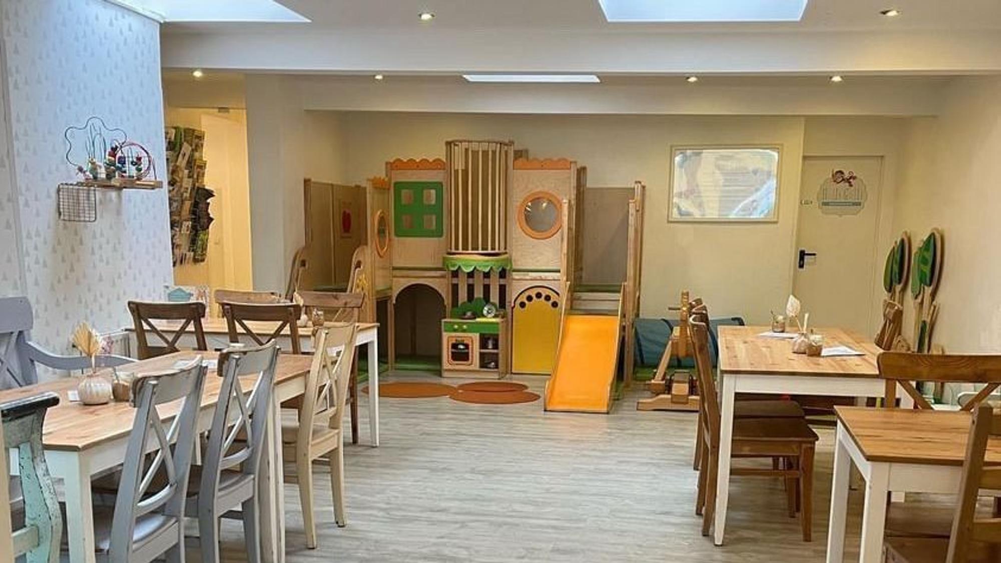Tische und Spielecke im Familiencafé Halli Galli Köln.
