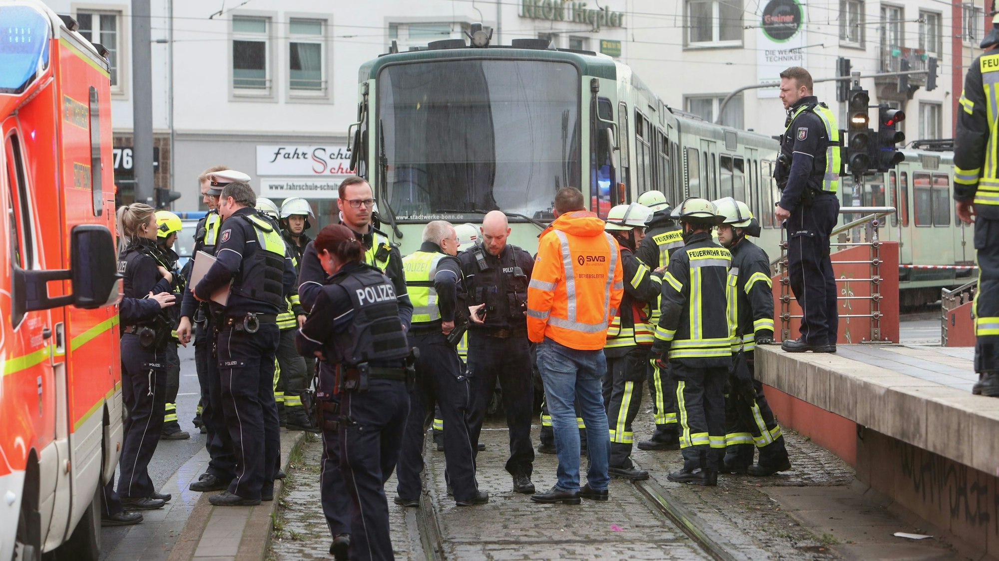 Rettungskräfte der Feuerwehr und Polizei stehen auf den Gleisen vor einer Straßenbahn in Bonn (Archivfoto).