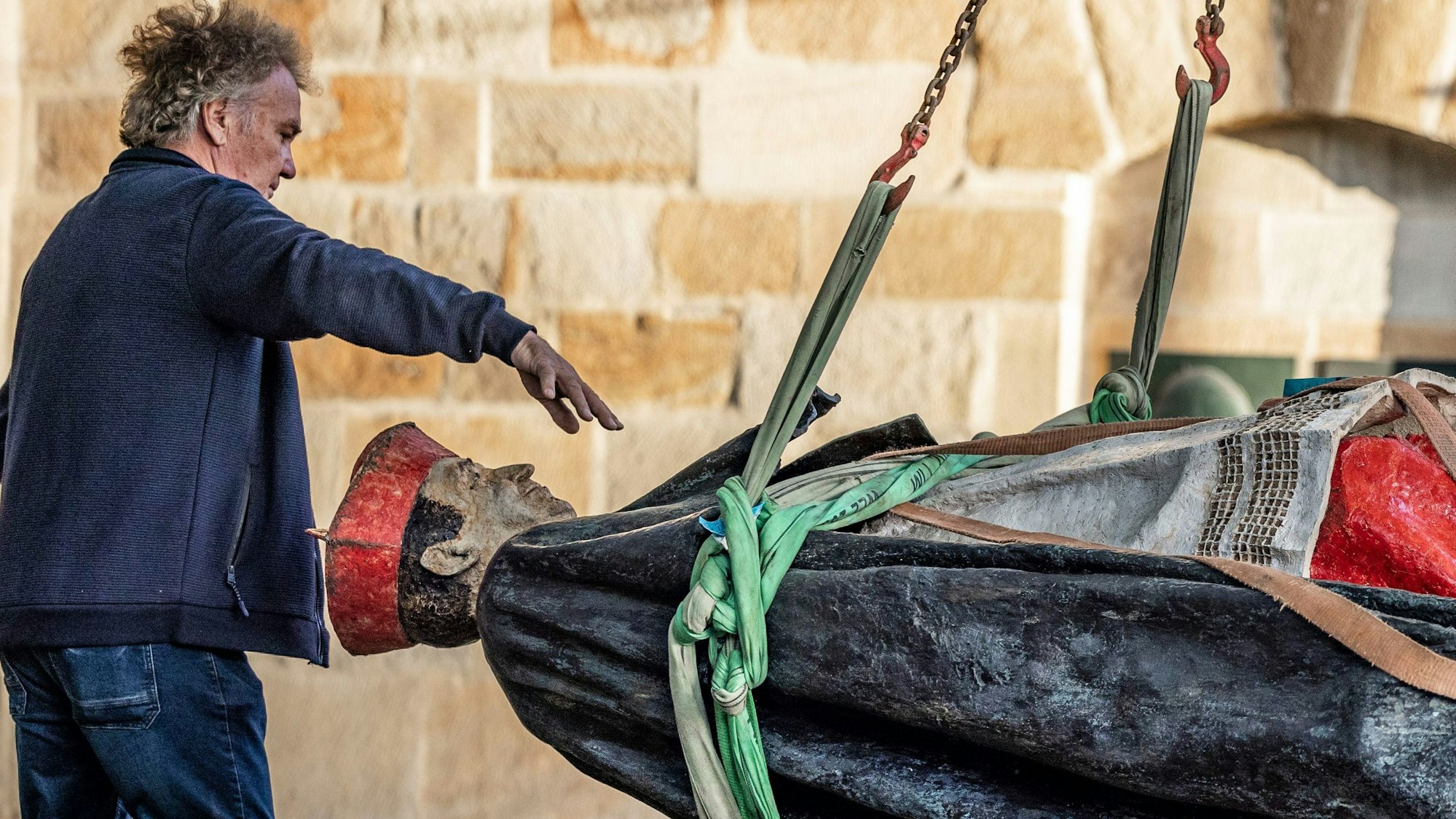 Die Skulptur des Essener Kardinals Franz Hengsbach hängt nach der Demontage vor dem Essener Dom im September an einem Kran und wird verladen.