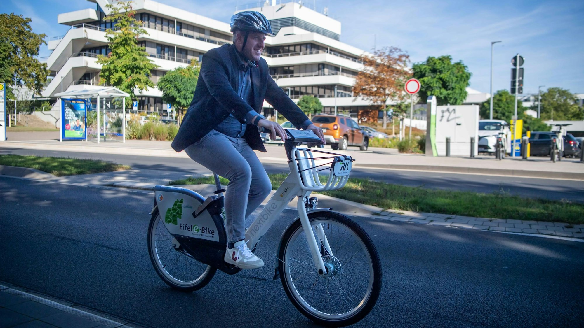 Das Bild zeigt Markus Ramers radelnd vor dem Kreishaus am Jülicher Ring.