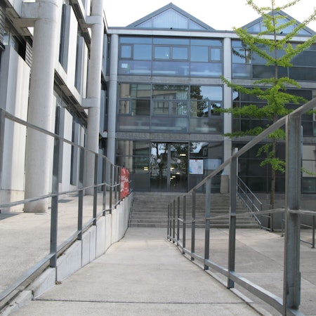 Das Bild zeigt den Eingang des Hennefer Rathauses mit Treppe und Rampe.