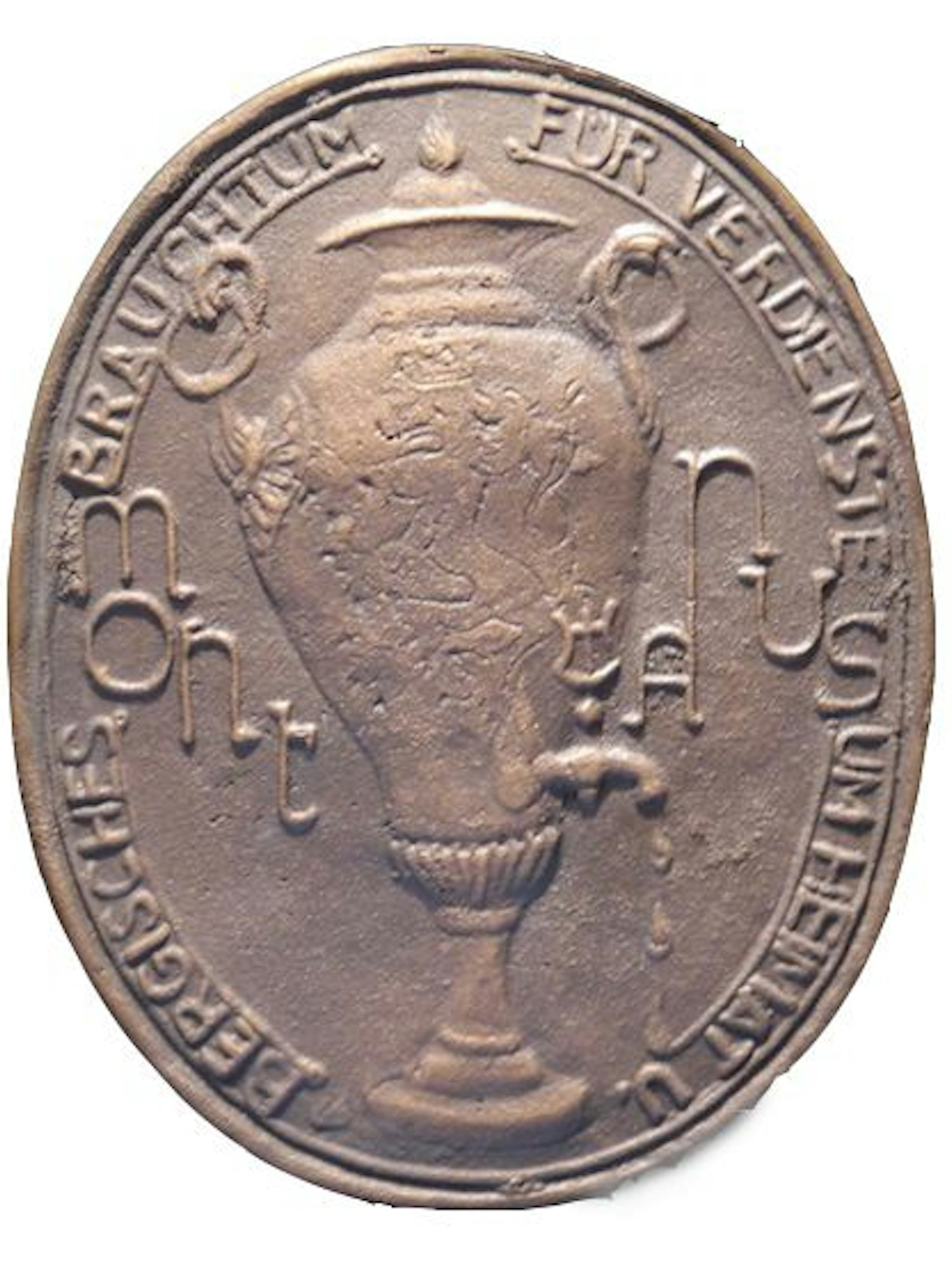 Auf einer Plakette mit Dröppelminna steht die Umschrift „Für Verdienste um Heimat und Bergisches Brauchtum“.