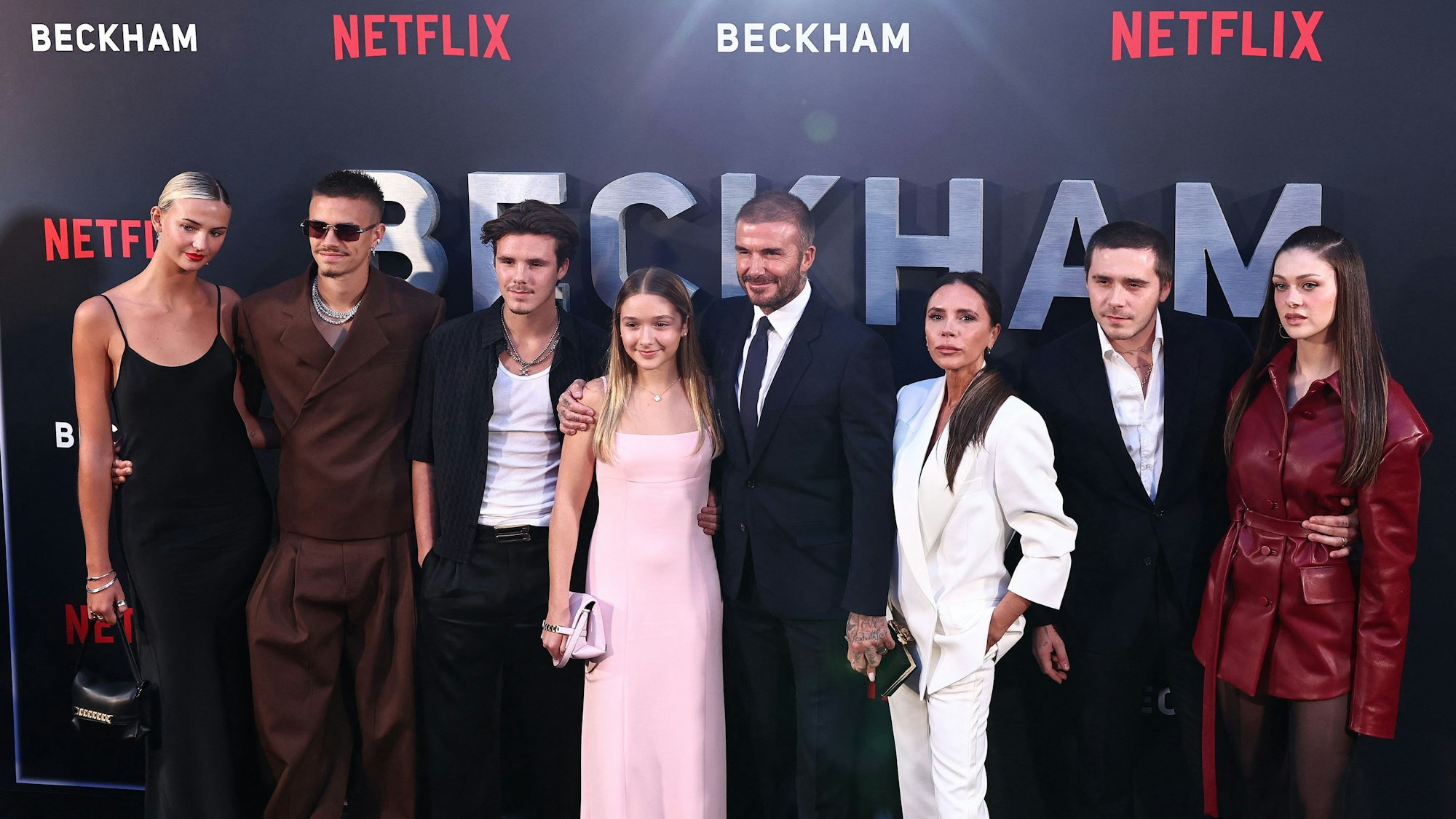 Der ehemalige englische Fußballspieler David Beckham (5l) und seine Frau Victoria Beckham (3r) posieren auf dem roten Teppich mit ihren Kindern und Partnern (von links) Mia Regan, Romeo Beckham, Cruz Beckham, Harper Beckham, Brooklyn Beckham, Nicola Peltz Beckham bei der Ankunft zur Premiere von „Beckham“ in London am 3. Oktober 2023.