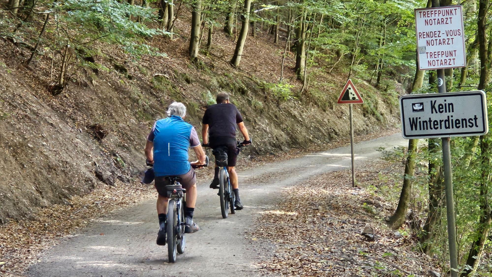 Zwei Fahrradfahrer sind von hinten zu sehen. Sie fahren auf der bei bei Wanderern und Radlern beliebten K7 am Urftsee.
