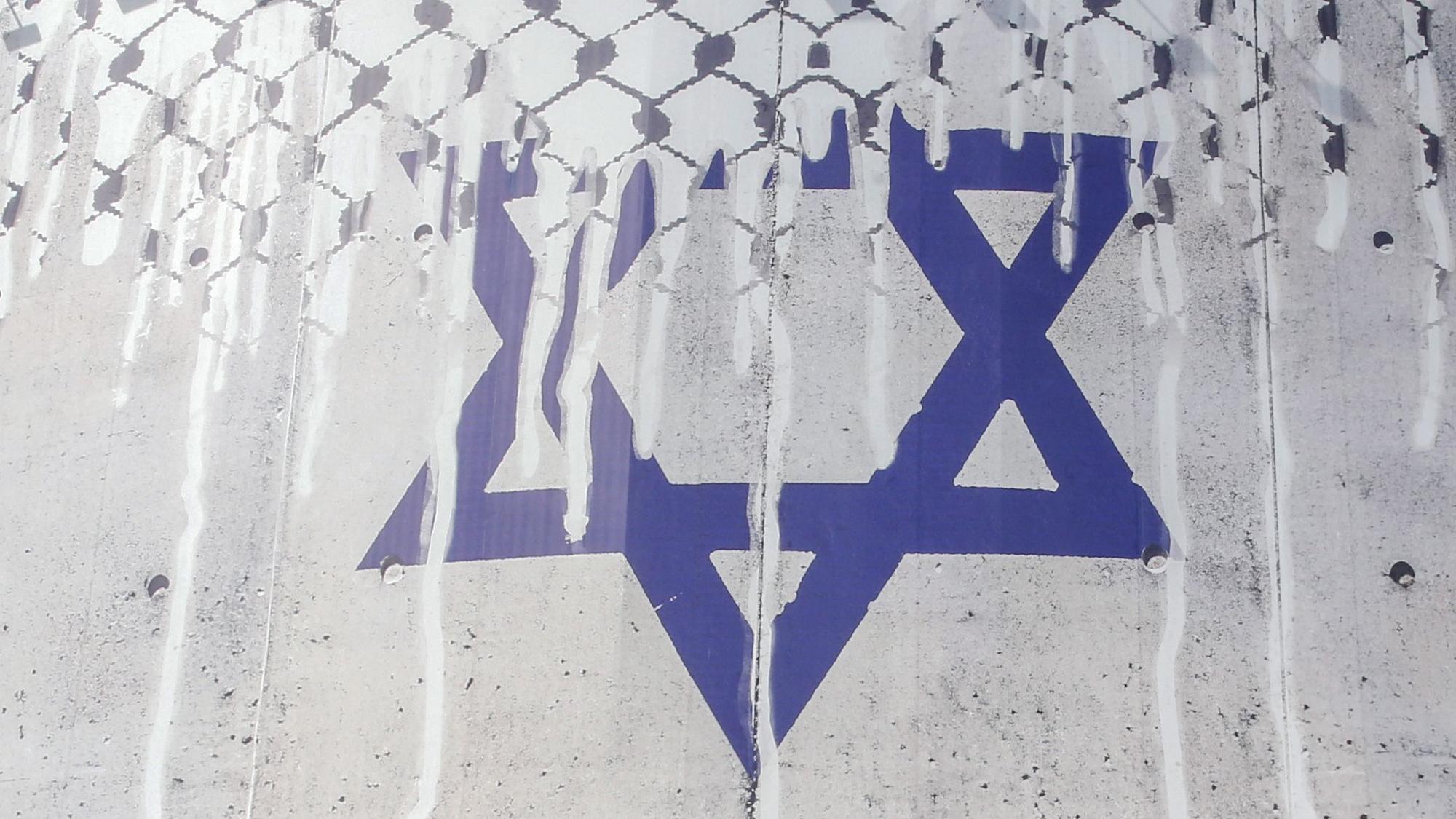 A man rides his motorcycle past an anti-Israel billboard with the chequerred keffiye covering the Star of David, entitled "Operation Al-Aqsa Flood," in solidarity with the Palestinians in Tehran's central Vali-Asr square on October 8, 2023. The Israeli-Palestinian conflict's bloodiest escalation in decades saw Hamas carry out a massive rocket barrage and ground, air and sea operation on October 7 that Israel's army said had killed more than 200 Israelis and wounded 1,000, while soldiers and civilians were taken hostage. (Photo by AFP)