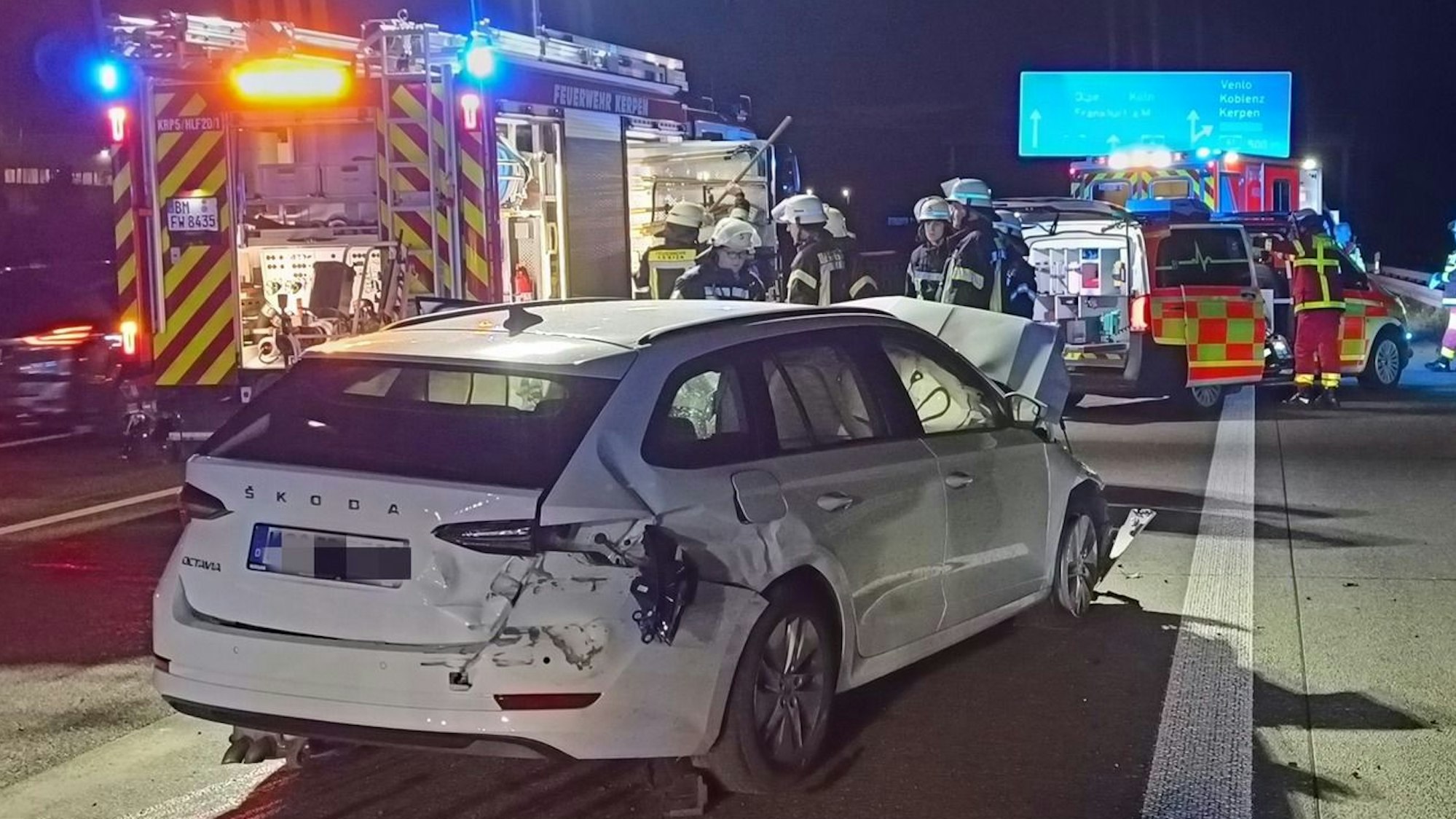Auf dem Foto sind mehrere Einsatzfahrzeuge der Feuerwehr und eines der am Unfall beteiligten Fahrzeuge zu sehen.
